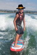 Youth wakesurfing with a pilgrim hat