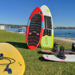 wakeboard, wakesurf boards, and surfboard on beach
