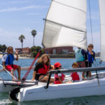 campers and instructor on sailboat