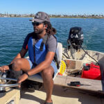 man driving small boat