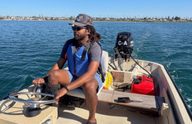man driving small boat